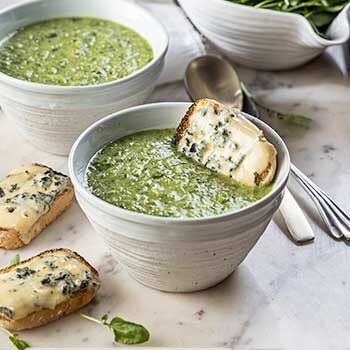 Watercress Soup in bowls and penny loaves with melted cheese