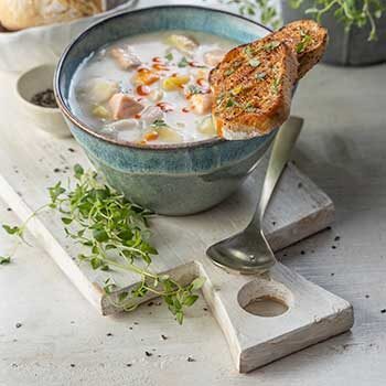 Chowder on a board with brown Penny Loaf