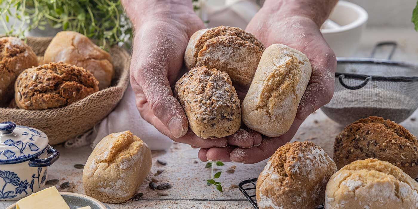 cupped hands holding a selection of Penny Loaves